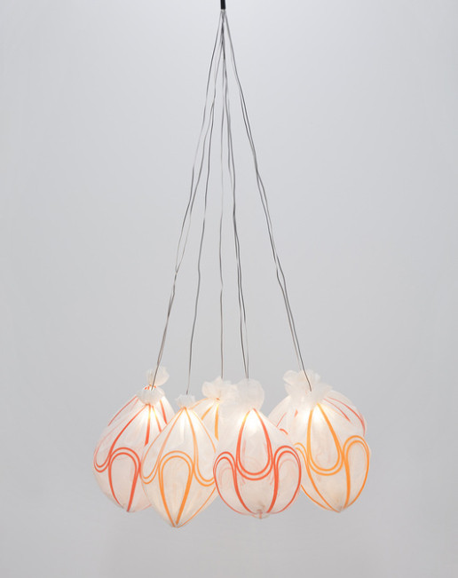 A cluster of pendant light fixtures of silk supported by 3D printed plastic parts