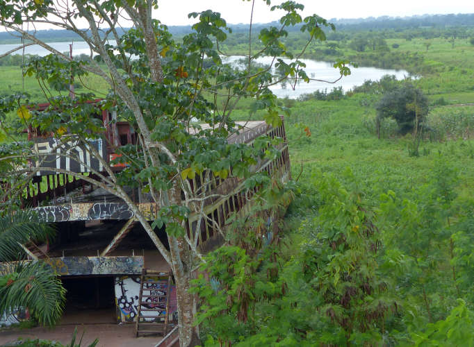 Grounded ferry surrounded by vegetation in front of Iquitos' Malecon Tarapacá