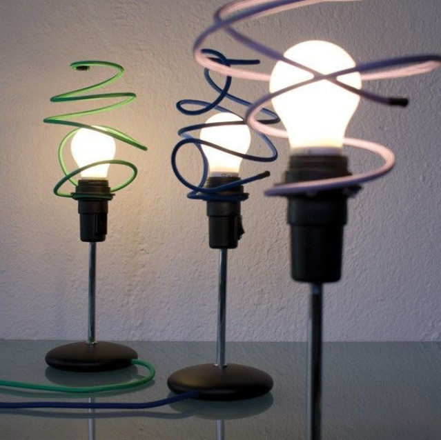 Table lamp with steel shade shaped in form of a squiggle