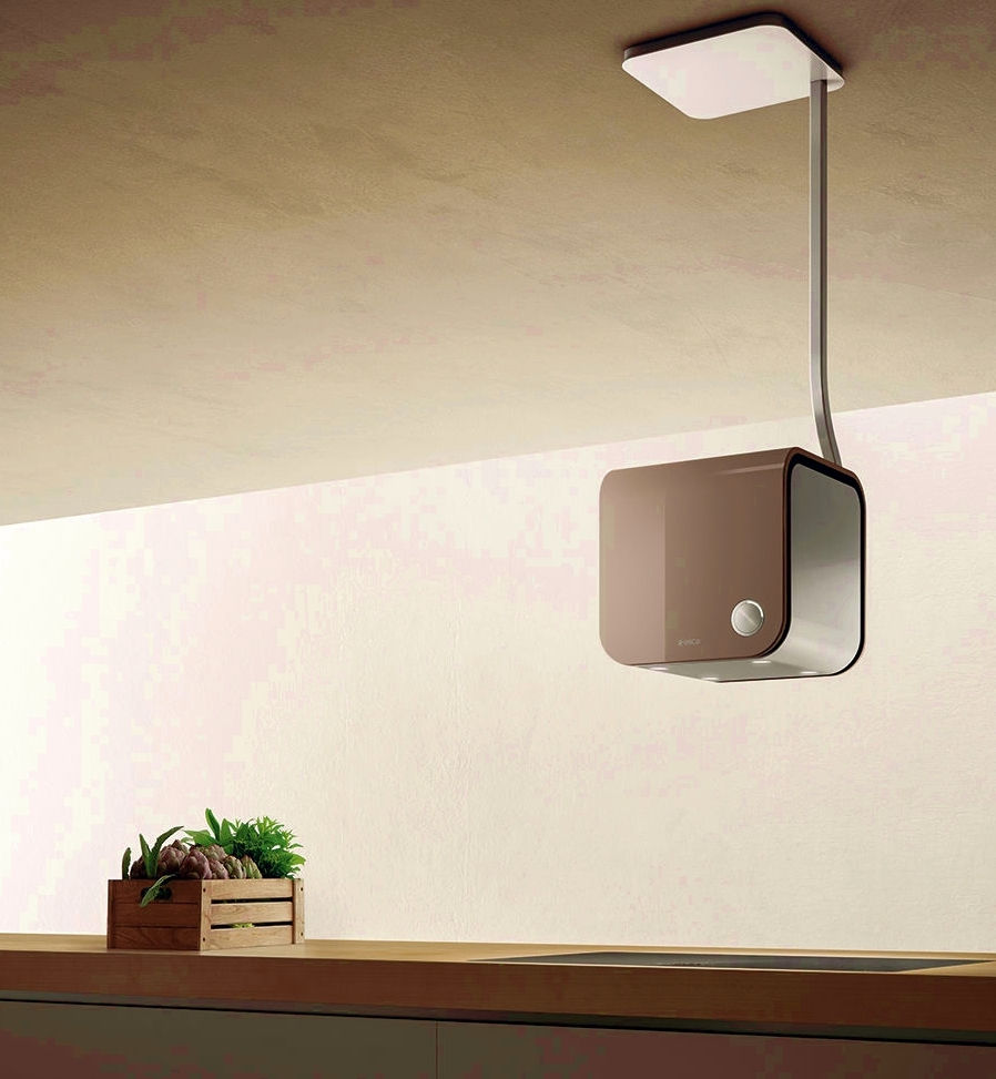 Taupe color island hood with slender ceiling connector resembling a stylized comma