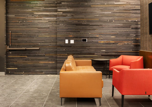 Wall and door covered with panels of recycled leather belts