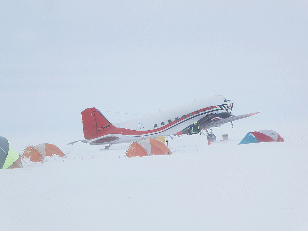 Flight crew digging plane out of snow drifts