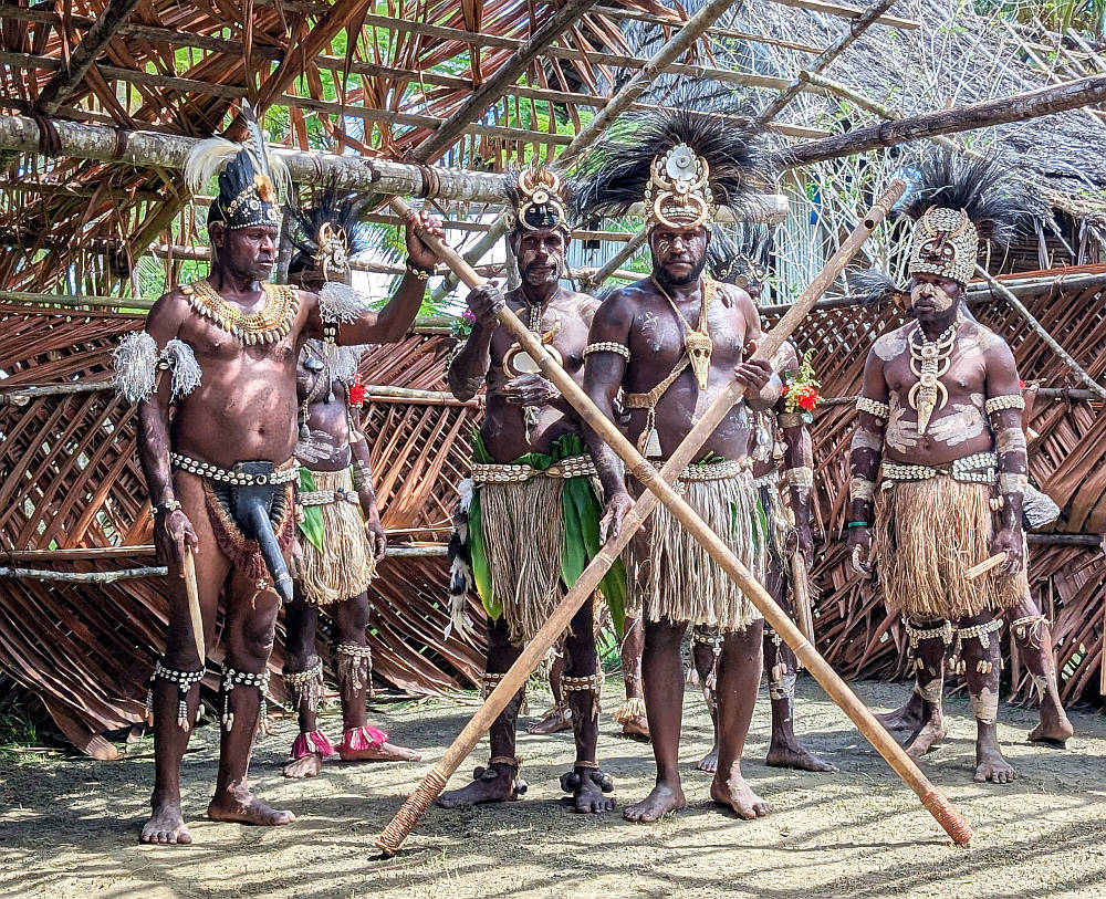 Sepik River village men with 2 long bamboo flutes