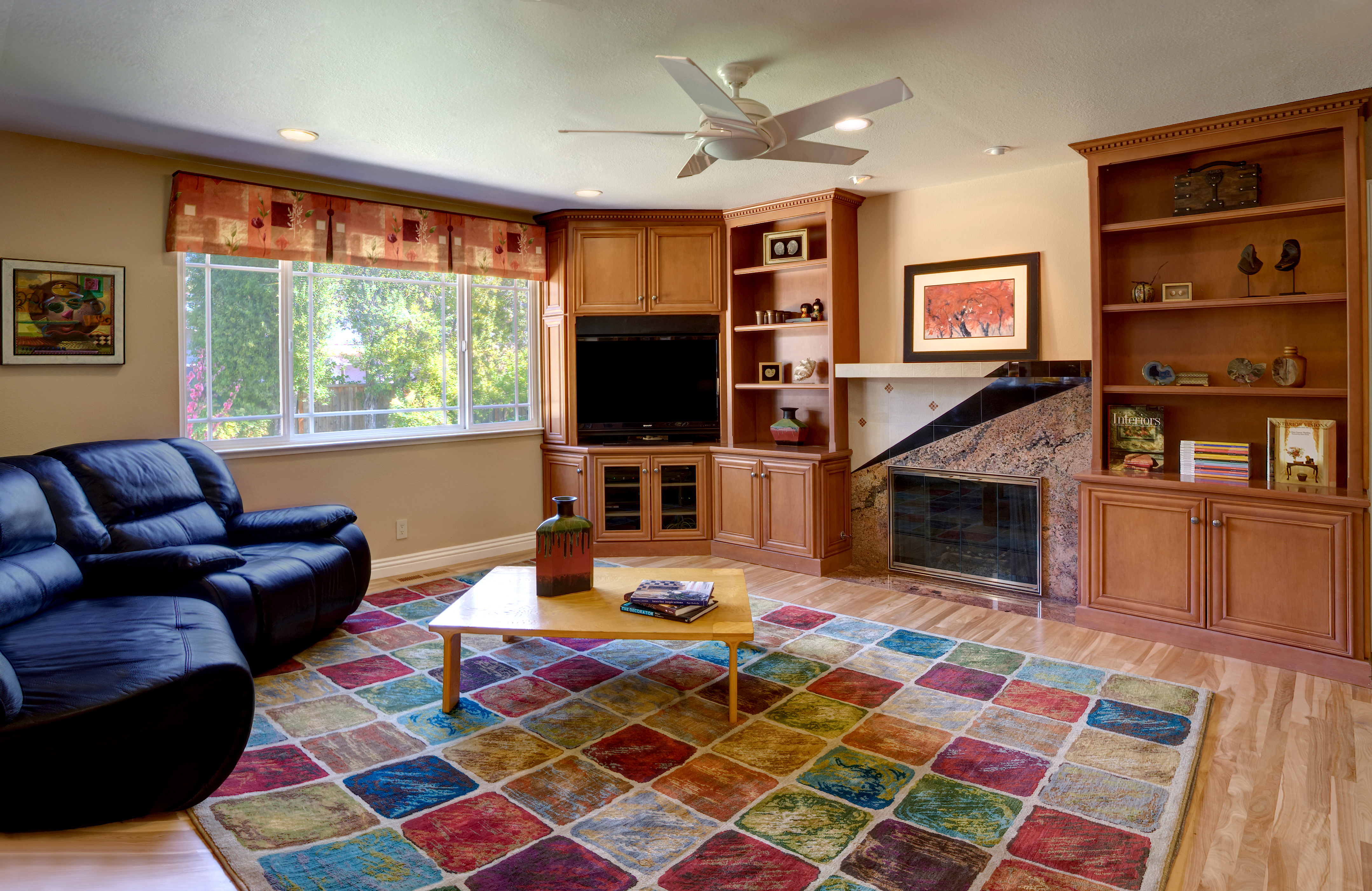 Remodeled Saratoga family room with new cabinetry, fireplace mantle, drapery and flooring